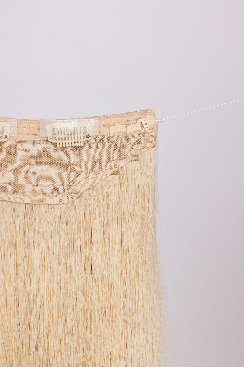 Close-up of BHBD hairband clip: hook & fishing line for adjustability.