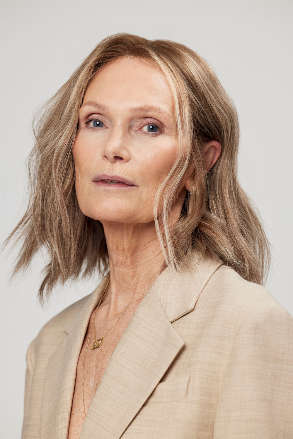 Woman wearing a BHBD Celeste Full lace wig with highlights.