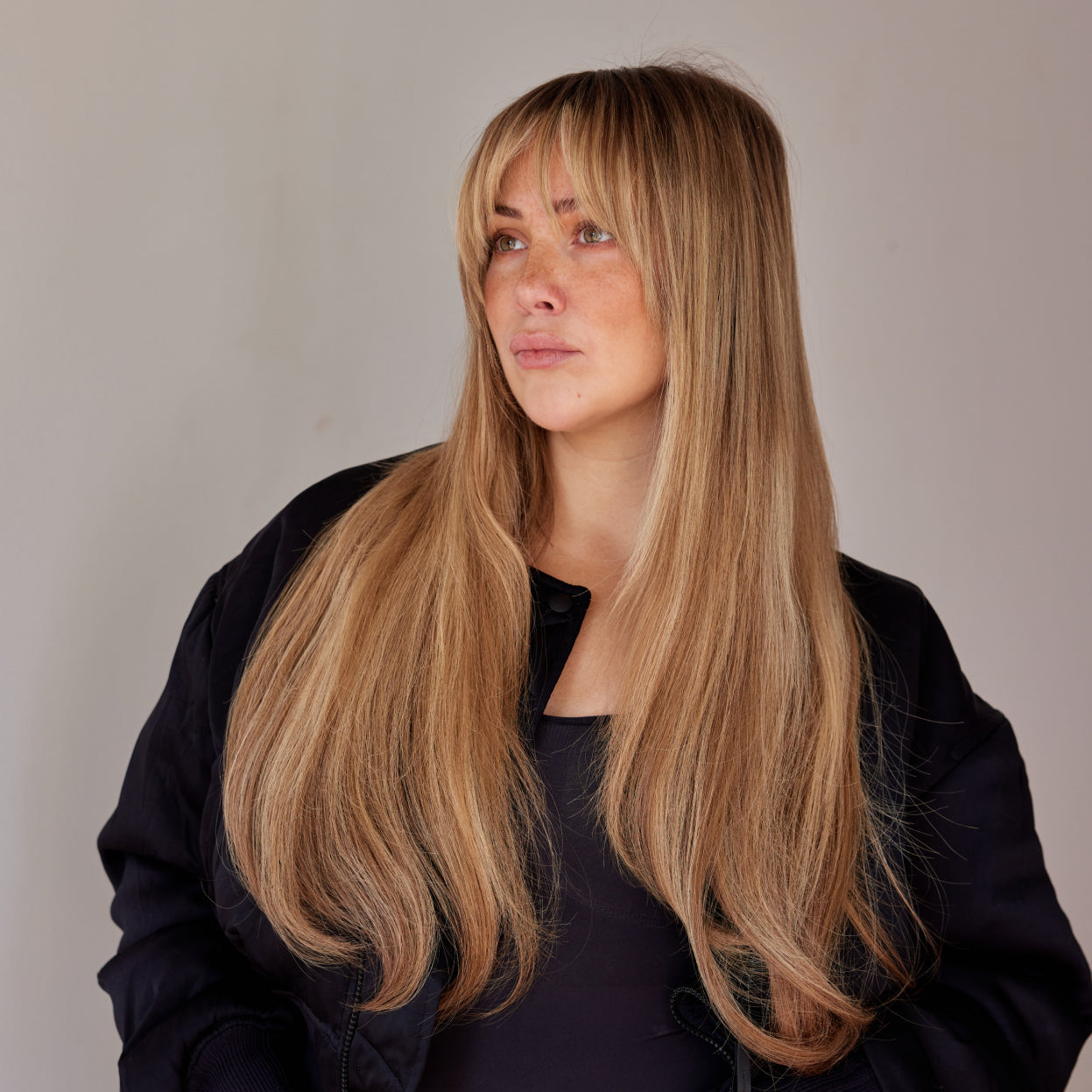 A woman with brown 60cm long BHBD hair extensions.