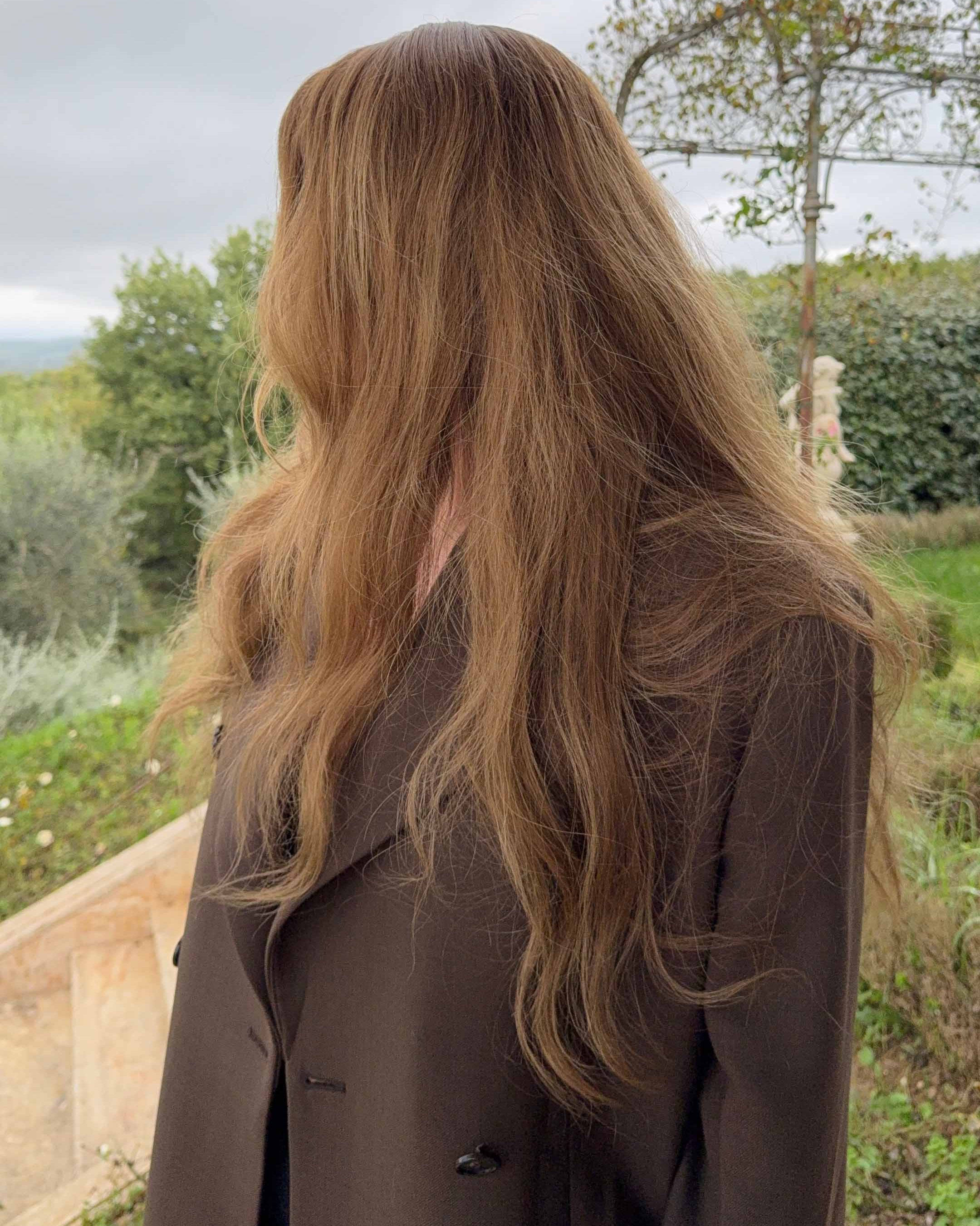 Woman wearing a BHBD Elena wig with blended balayage, soft caramel brown tones, and cool medium brown lengths.