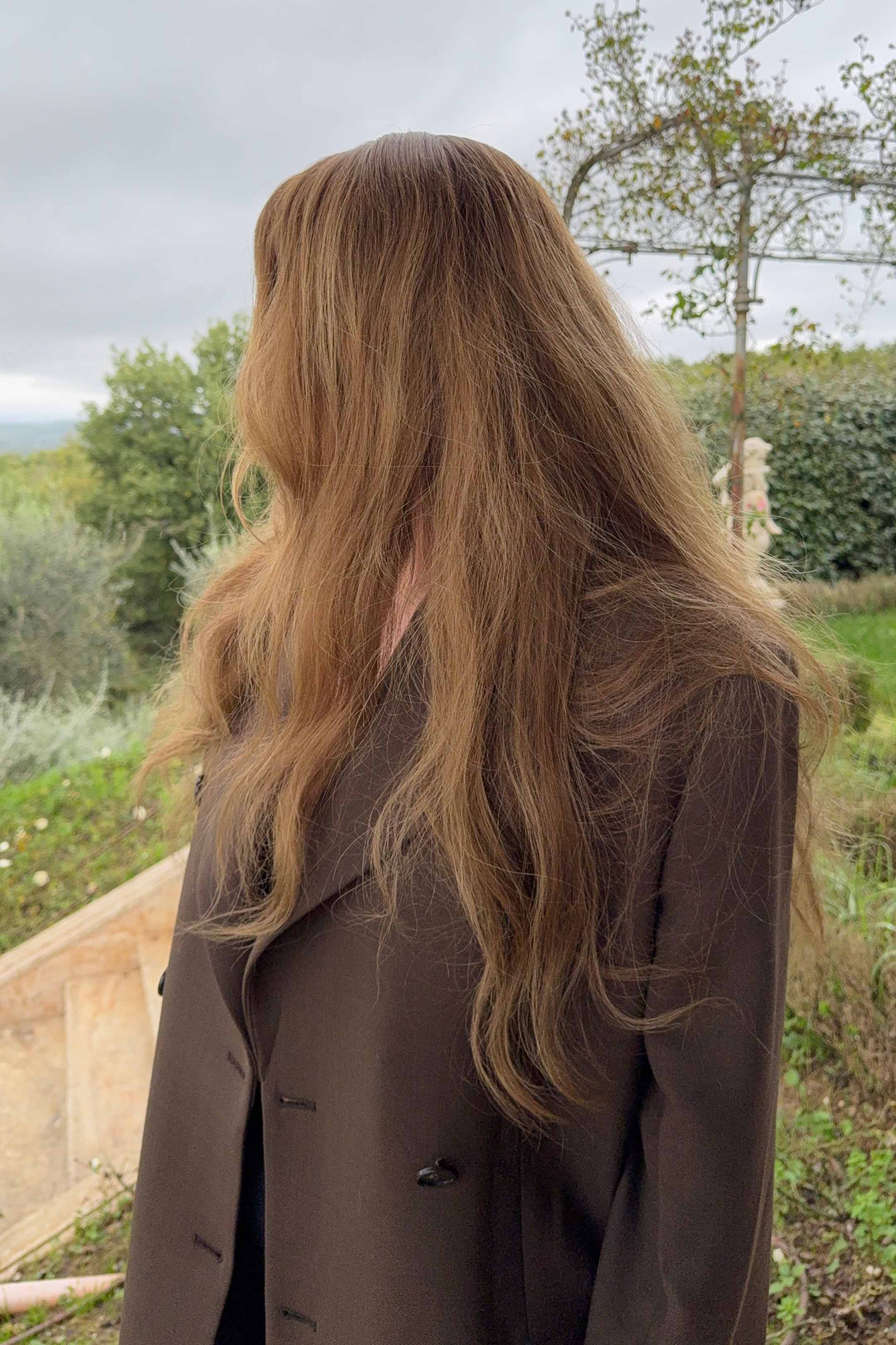 Woman wearing a BHBD Elena wig with blended balayage, soft caramel brown tones, and cool medium brown lengths.