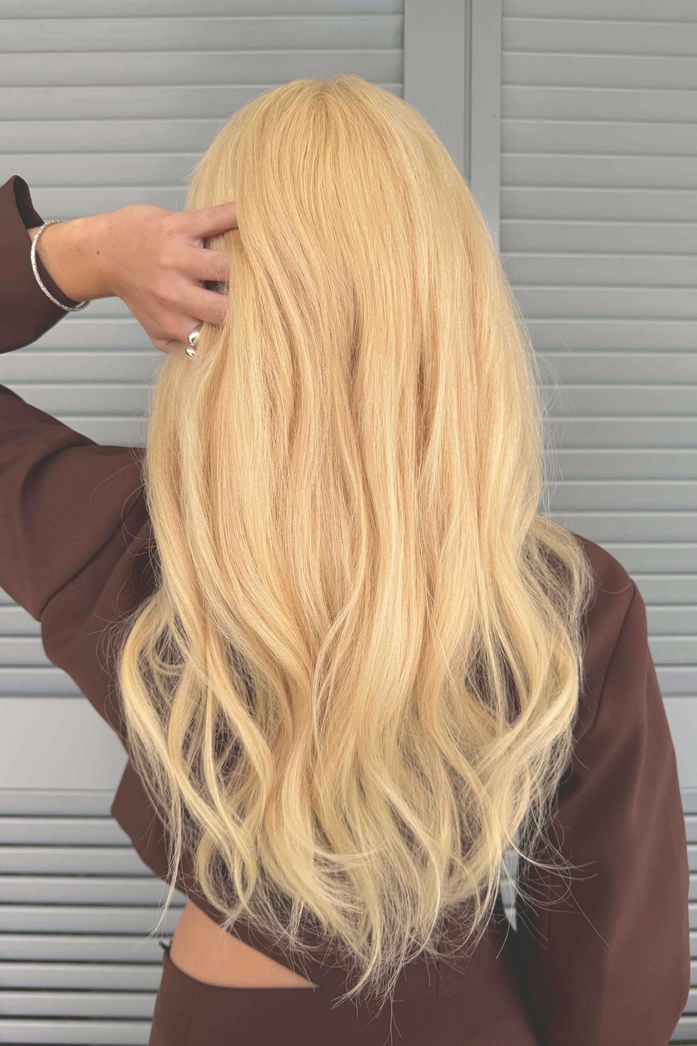Long BHBD Livia wig with warm blonde shade.