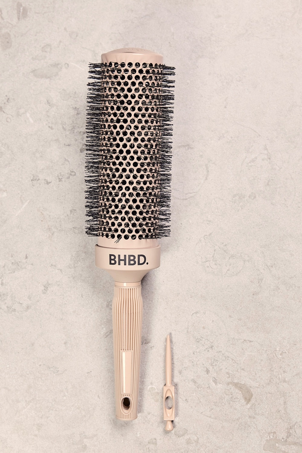 BHBD round brush with ergonomic handle and detachable sectioning tool, designed for precise styling and efficient blow-drying, placed on a neutral background.